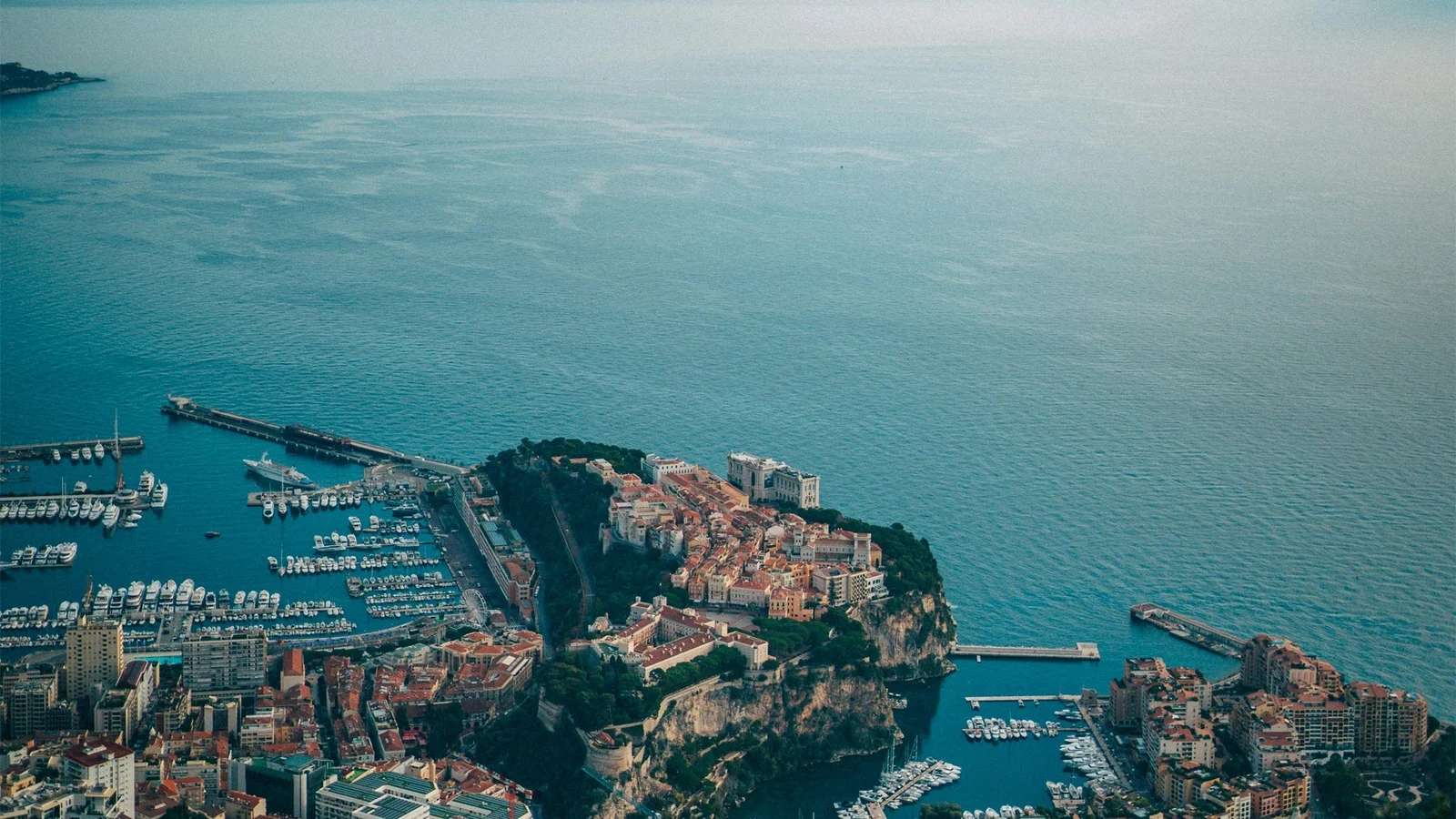 Monaco's Mediterranean coastline, harbor and warm-toned buildings